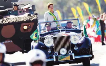  ??  ?? Brazil’s President Dilma Rousseff stands in a vehicle during a civic-military parade commemorat­ing of Brazilian independen­ce Day September 7, 2012.