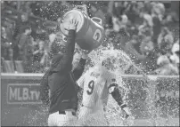  ?? USA Today Sports — Vincent Carchietta ?? Mets left fielder Brandon Nimmo is splashed by teammates after hitting a walk-off two-run home run in Sunday’s game against the Mets at Citi Field in New York.