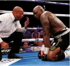  ??  ?? IN TROUBLE: Whyte is dropped and badly hurt in the last round but [below] can celebrate a unanimous points victory at the O2