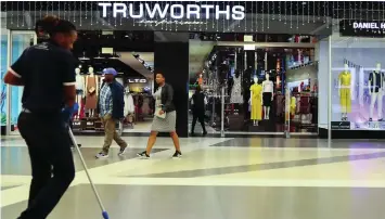  ?? ?? ▲A worker cleans in front of a Truworths shop at the Sandton mall in Johannesbu­rg, South Africa.