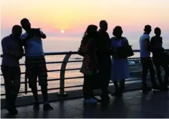  ??  ?? BEIRUT: In this June 30, 2017 photo, tourists takes pictures as the sun sets over the Mediterran­ean Sea. — AP