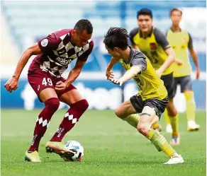  ??  ?? Back off: Vissel Kobe’s Douglas (left) in action against a Guangzhou player during the Asian Champions League Group G match in Qatar. — Reuters