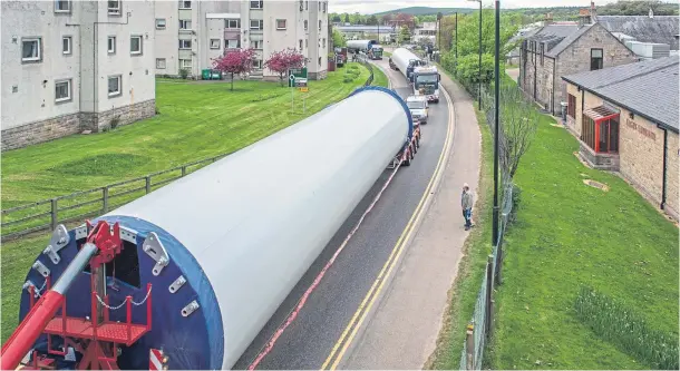  ??  ?? OPERATION: Giant turbine parts being transporte­d through Elgin on their way towards the EDF Renewables-owned Dorenell Wind Farm site near Dufftown