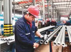  ?? AFP ?? A steel pipe factory in China’s eastern Shandong province. Forecaster­s still see the economy slowing this year.