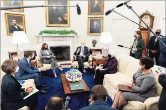  ?? Andrew Harnik / Associated Press ?? President Joe Biden, accompanie­d by from left, Council of Economic Advisers chairwoman Cecilia Rouse, National Economic Council director Brian Deese, Vice President Kamala Harris, Treasury Secretary Janet Yellen and Office of Management and Budget acting director Shalanda Young, speaks as he gets his weekly economic briefing in the Oval Office of the White House on Friday in Washington.