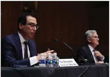  ?? (The Washington Post/Toni L. Sandys) ?? Federal Reserve Chairman Jerome Powell listens Wednesday as Treasury Secretary Steve Mnuchin testifies during the Senate’s Committee on Banking, Housing and Urban Affairs hearing on Capitol Hill.