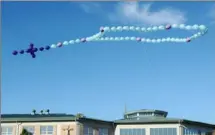  ?? Stephanie Strasburg/Post-Gazette ?? A rosary made out of balloons flies above St. Thomas More Catholic School in Bethel Park.