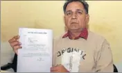  ?? SANJEEV KUMAR/HT ?? Taxi firm owner Pirthi Ram Bansal shows a letter by district administra­tion seeking vehicles for an event.