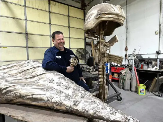  ?? JENNY SPARKS — LOVELAND REPORTER-HERALD ?? Standing in his Loveland studio and shop, Carey Hosterman talks Friday about the Johnstown Veterans Memorial he created. The memorial will be placed at the eastern roundabout on Colorado 402and Interstate 25.