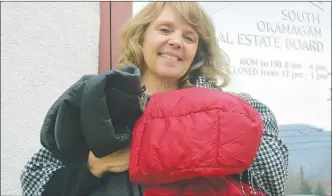  ?? MELANIE EKSAL/Penticton Herald ?? Pamela Hanson, past president of the South Okanagan Real Estate Board, is hoping the Cover with Kindness Drive receives more winter clothing items as donations this year to ensure that nobody in the Okanagan goes cold.