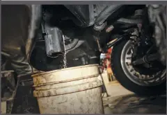  ??  ?? Because installati­on of the exhaust brake means you have to tap into the coolant system at the block, all engine coolant has to be drained. With a clean 5-gallon bucket positioned under it, the 17-mm drain plug was opened up and the radiator cap removed.