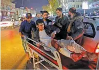  ?? Reuters ?? Afghan men carry an injured person to a hospital after a suicide attack in Kabul on Tuesday. Dozens were killed in a suicide bomb attack on a meeting of top clerics in Kabul on Tuesday.