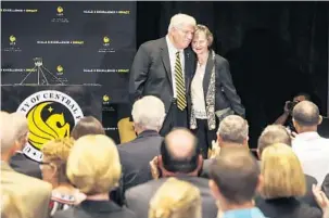  ?? JACOB LANGSTON/STAFF PHOTOGRAPH­ER ?? Above, UCF President John Hitt embraces his wife Martha after announcing he will retire in June 2018. Below, the Hitts talk to student Shaka Cooper during a reception on Hitt’s first day on the job in 1992.