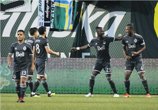  ?? — THE ASSOCIATED PRESS ?? Whitecaps players celebrate an early goal by Kei Kamara as they jumped out in front of the host Portland Timbers just 14 minutes into the contest on Saturday night. Vancouver held on despite a furious rally by the Timbers to record a 2-1 victory.