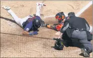  ??  ?? Minnesota Twins’ Luis Arraez, left, is tagged out by Houston Astros catcher Martin Maldonado as he attempted to score on a Marwin Gonzalez single in the fifth inning of Game 2of an American League wild-card baseball series, Wednesday, in Minneapoli­s.