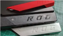  ??  ?? You can easily swap out the red corner accents of the ROG Strix G15 Advantage Edition for either a clear or silver color. All three options are included with the laptop.