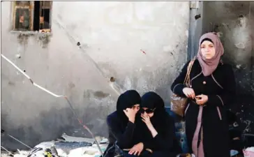  ?? LOUAI BESHARA/AFP ?? Residents of al-Qaboun, in Damascus, wait in an area designated by the Syrian government after the suburb was retaken by regime forces, on Tuesday.