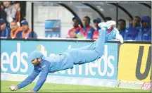  ??  ?? India’s Dinesh Karthik dives to take the catch after saving it over the boundary to dismiss New Zealand’s Daryl Mitchell for 8 during the Twenty20 cricket internatio­nal between New Zealand and India in Wellington, NewZealand, Feb 6. (AP )