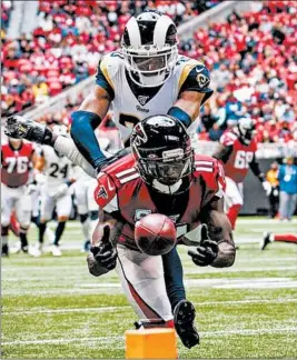  ?? CARMEN MANDATO/GETTY ?? The Rams’ Jalen Ramsey tries to take down Falcons receiver Julio Jones (11) last month.