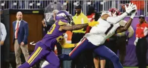  ?? David Berding / Getty Images ?? The Patriots’ DeVante Parker catches a pass over the Vikings’ Duke Shelley on Thursday.