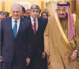  ?? — AP ?? Saudi King Salman ( right) receives Turkish Prime Minister Binali Yildirim in Riyadh, Saudi Arabia on Wednesday. Saudi King Salman and Turkey’s premier discussed boosting ties and the status of Jerusalem.