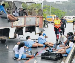  ??  ?? HELP IS ON THE WAY: Pupils ham it up as the ‘victims’ of a bus accident on Port Alfred’s Nico Malan Bridge, a simulation to test coordinate­d rescue response efforts in times of disaster