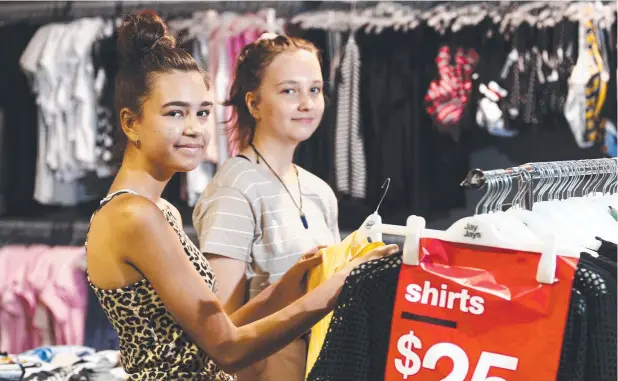  ?? Picture: BRENDAN RADKE ?? BARGAIN HUNTERS: Mia Stewart and Emilia Vaikko shop for clothing at Jay Jays store at the DFO shopping centre, Westcourt.