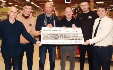  ??  ?? €30,700 raised for charity Aoibheann’s Pink Tie was handed over in Tesco Gorey last week. From left: Colin ‘Jango’ Fleming, Conor McDonald, Paul McGrath, Nick Rochford of Aoibheann’s Pink Tie, Basil Kennedy and Tesco deputy manager Niall Kennedy.