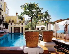  ?? ?? FIT FOR THE GLITTERATI: The pool at the Poseidon Grand Hotel in Greece, far left. Centre:
A cool courtyard at La Mamounia in Marrakech. Left: The Hassler’s Salone Eva