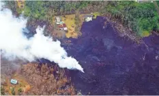  ?? TREVOR HUGHES/ USA TODAY ?? Lava has swallowed Pahoa, forcing 2,000 people to flee; now Kilauea volcano itself appears ready to explode.
