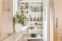  ??  ?? This butler's pantry is tucked out of sight of the main kitchen and offers plenty of storage space.