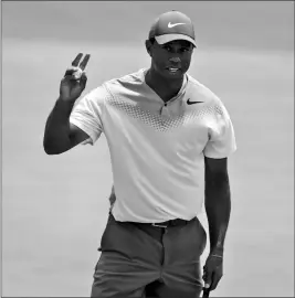  ?? ASSOCIATED PRESS ?? TIGER WOODS waves on the 18th green during the third round of the Players Championsh­ip golf tournament, Saturday in Ponte Vedra Beach, Fla.