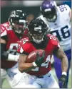  ??  ?? In this Sunday file photo, Atlanta Falcons running back Devonta Freeman (24) runs against the Minnesota Vikings during the first half of an NFL football game in Atlanta.