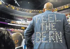  ?? BENJAMIN HAGER/ LAS VEGAS REVIEW-JOURNAL ?? Sanjay Patel wears a coat showing his support for vanquished Democratic presidenti­al candidate Sen. Bernie Sanders, I-Vt., during the third day of the Democratic National Convention on Wednesday at Philadelph­ia.