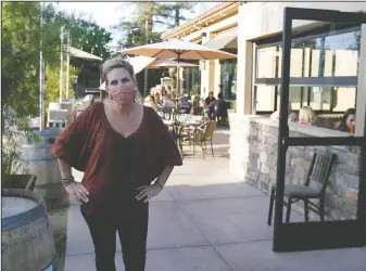  ?? DAVID WITTE/NEWS-SENTINEL ?? Papapavlo's Bistro and Bar owner Jennifer Pappas in the outdoor patio area on Tuesday. The restaurant, which recently opened the Lodi location, will be able to serve people inside after San Joaquin County was promoted to the red tier on Tuesday.