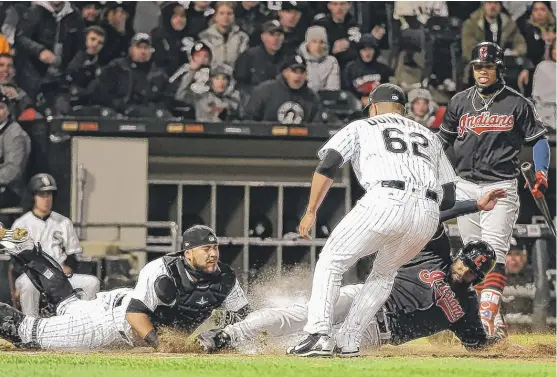  ?? | GETTY IMAGES ?? Indians outfielder Austin Jackson scores on a wild pitch as Sox catcher Omar Narvaez tries to tag him in the third inning Friday at Guaranteed Rate Field.