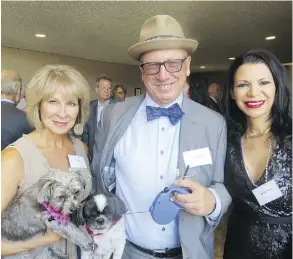  ??  ?? Getting ready to walk the red carpet with their pets at the Haute Dawg gala at the Westin Hotel last week are, from left, Jill Didow, Greg Christenso­n and Karyn Decore. The event supported the Edmonton Humane Society, Dogs with Wings and will also help fund a mobile animal surgical unit.