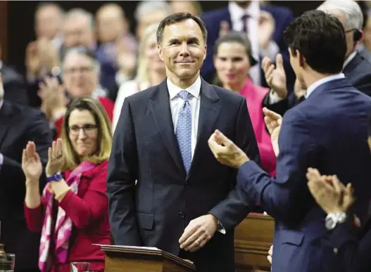  ?? SEAN KILPATRICK / THE CANADIAN PRESS ?? Prime Minister Justin Trudeau and MPs applaud as Finance Minister Bill Morneau rises to deliver the federal budget in the House of Commons on Tuesday.