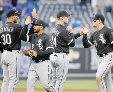  ?? CHARLIE RIEDEL/ AP ?? The White Sox celebrate their Opening Day beatdown of the Royals in Kansas City on Thursday. The record- setting Sox knocked it out of the park six times.