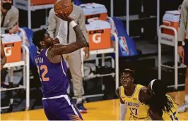  ?? GARY A. VASQUEZ/USA TODAY SPORTS ?? Suns center Deandre Ayton (22) shoots against the Lakers during the second half Tuesday in Los Angeles.