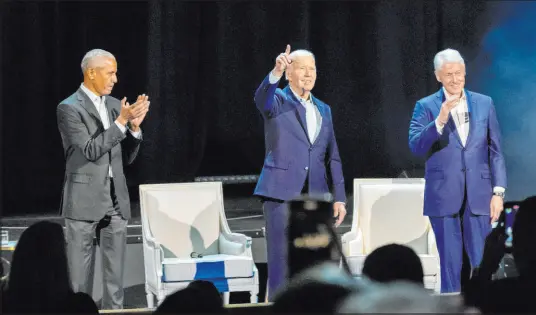  ?? Alex Brandon The Associated Press ?? President Joe Biden, center, and former Presidents Barack Obama and Bill Clinton participat­e in a fundraisin­g event Thursday night with late-night host Stephen Colbert at a sold-out gathering at Radio City Music Hall.