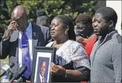  ?? Daniel Sangjib Min Richmond Times-Dispatch ?? CAROLINE OUKO holds a photo of son Irvo Otieno in Dinwiddie, Va., last week. He died in custody.