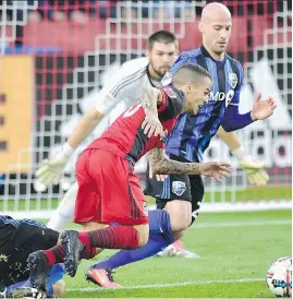  ?? GUNN/THE CANADIAN PRESS FRANK ?? Toronto FC forward Sebastian Giovinco is fouled in the box by Montreal Impact defender Victor Cabrera, left, at BMO Stadium on Sunday in Toronto. TFC was a 1-0 winner.