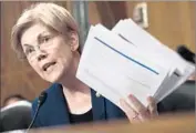  ?? Saul Loeb AFP/Getty Images ?? SEN. ELIZABETH WARREN holds Wells Fargo earnings call transcript­s as she questions bank CEO.