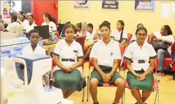  ??  ?? Students waiting to receive their free spectacles at the Courts Optical Main Street branch yesterday. (Photo by Terrence Thompson)