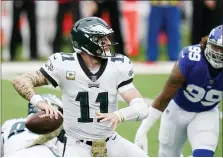  ?? SETH WENIG — THE ASSOCIATED PRESS ?? Philadelph­ia Eagles quarterbac­k Carson Wentz (11) looks to throw a pass during the first half of an NFL football game against the New York Giants, Sunday, Nov. 15, 2020, in East Rutherford, N.J.