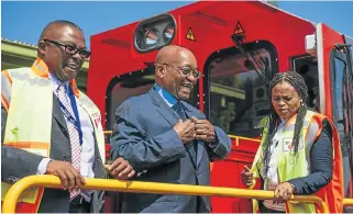  ?? /Waldo Swiegers /Bloomberg ?? On track? President Jacob Zuma, centre, in a jolly mood while standing aboard a train as he attends the launch of a new trans-Africa locomotive at Transnet’s engineerin­g site in Pretoria on Tuesday.