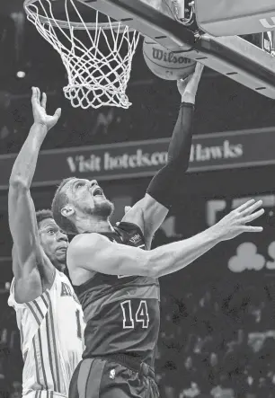  ?? DALE ZANINE/USA TODAY SPORTS ?? Pistons guard Malachi Flynn goes to the basket past Hawks forward De’Andre Hunter during the second half Wednesday in Atlanta.