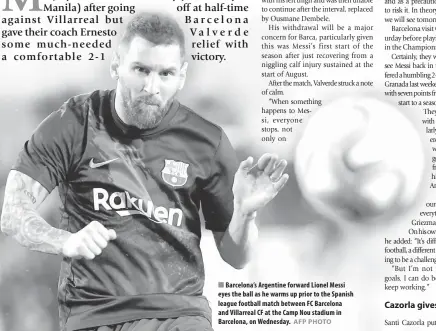  ?? AFP PHOTO ?? Barcelona’s Argentine forward Lionel Messi eyes the ball as he warms up prior to the Spanish league football match between FC Barcelona and Villarreal CF at the Camp Nou stadium in Barcelona, on Wednesday.