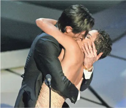  ??  ?? Best-actor winner Adrien Brody plants a kiss to remember on presenter Halle Berry in 2003. ROBERT HANASHIRO/USA TODAY